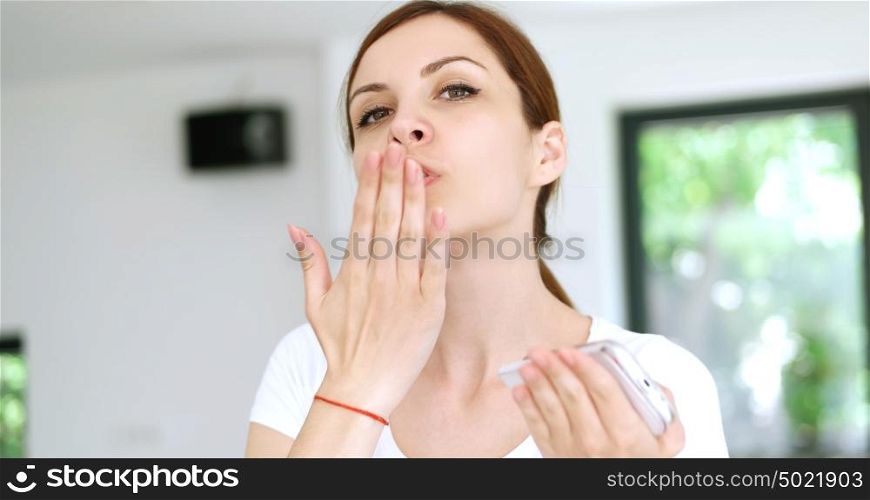 Beautiful Young Woman Sending Air Kiss To Camera