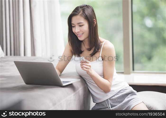 Beautiful young woman shopping online