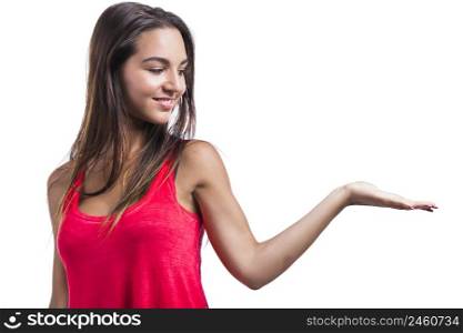Beautiful young woman showing something on her hand, isolated over a white background