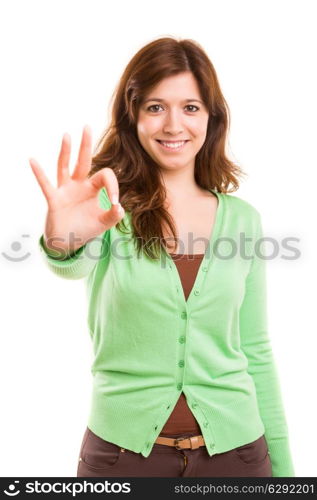 Beautiful young woman signaling ok, isolated over copy space background