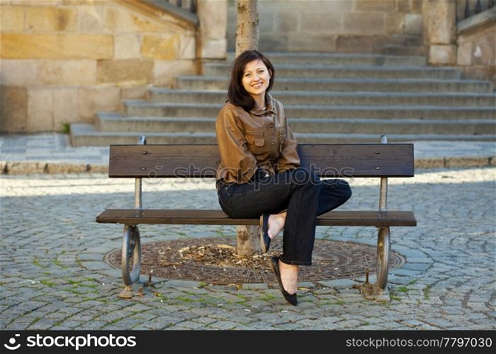 beautiful young woman sitting on a bench