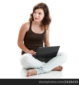 Beautiful young woman sitting on floor with a laptop, isolated on white