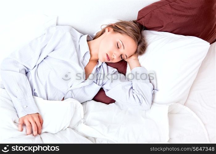 Beautiful young woman sleeping in a bed