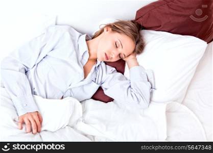 Beautiful young woman sleeping in a bed