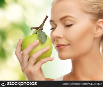 beautiful young woman smelling fresh green apple