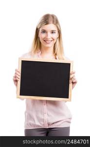Beautiful young woman smiling and showing something on a chalkboard, isolated over a white background