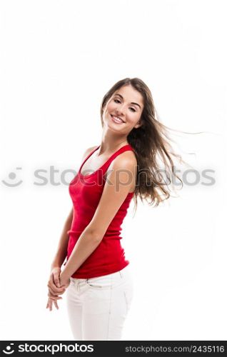 Beautiful young woman smiling and standing over a white background
