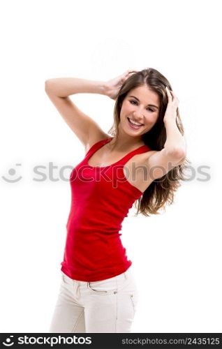 Beautiful young woman smiling and standing over a white background