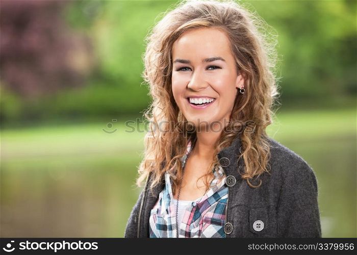 Beautiful young woman smiling outdoors in park