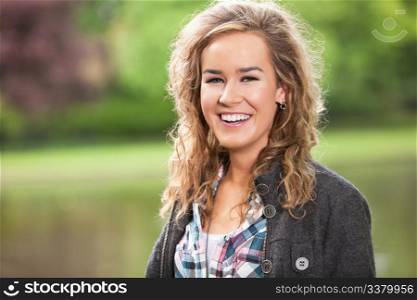 Beautiful young woman smiling outdoors in park