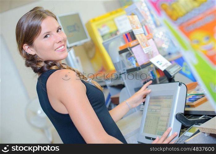 beautiful young woman smiling while using a screen