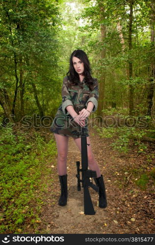 Beautiful young woman soldier with a M16 rifle