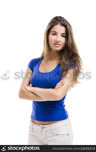 Beautiful young woman standing with arms crossed over a white background