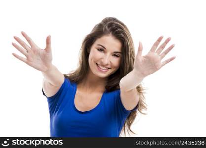 Beautiful young woman standing with her arms open, isolated over a white background