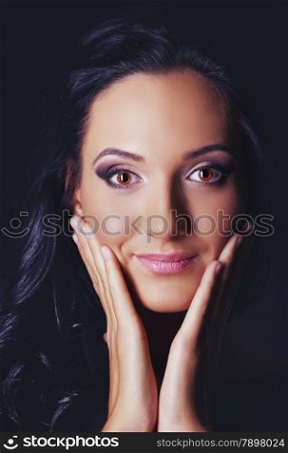 beautiful young woman studio portrait, black background