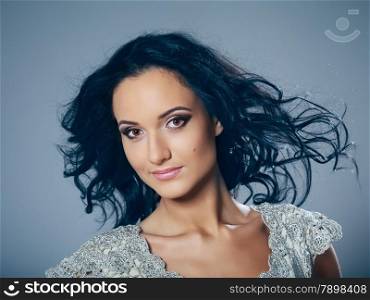 beautiful young woman studio portrait, gray background