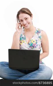 beautiful young woman talking over the phone and using laptop