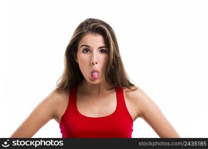 Beautiful young woman throwing tongue out, isolated over white background