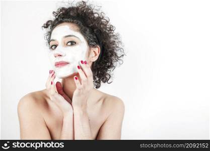 beautiful young woman touching her face mask isolated white background