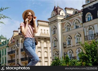 Beautiful Young Woman tourist in the City Center talking on the phone.. Beautiful Young Woman tourist in the City Center talking on the phone
