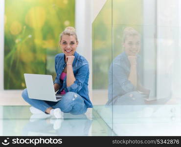 beautiful young woman using laptop computer on the floor at home