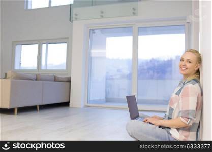 beautiful young woman using laptop computer on the floor at home