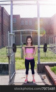 Beautiful young woman using weights during a workout. Industrial Excavator