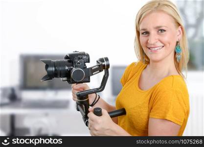 beautiful young woman videographer using steady cam