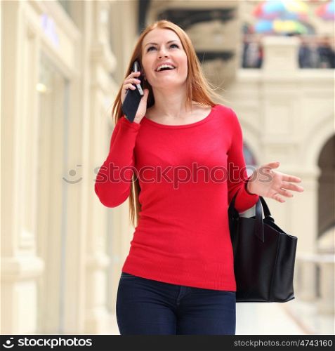 Beautiful young woman walking in the shop