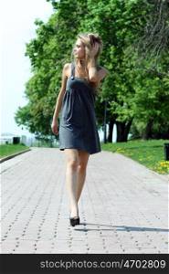 Beautiful young woman walking on the street