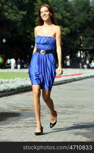 Beautiful young woman walking on the street