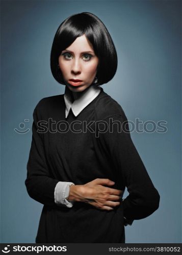 Beautiful young woman wearing pullover and shirt - studio shot