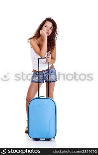 Beautiful young woman with a blue suitcase, isolated on white background