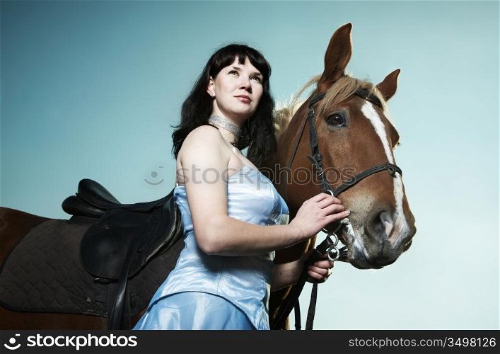 Beautiful young woman with a brown horse
