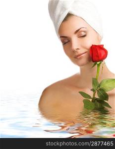 Beautiful young woman with a rose in water