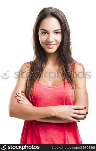 Beautiful young woman with arms crossed over a white background