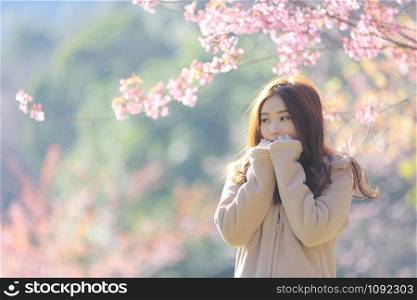 beautiful young woman with blooming cherry blossoms sakura flowers
