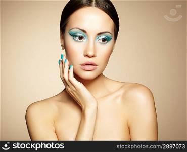 Beautiful young woman with bright make-up and manicure. Beauty fashion
