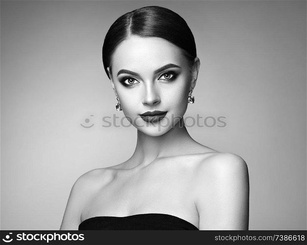 Beautiful Young Woman with Clean Fresh Skin. Perfect Makeup. Beauty Fashion. Eyelashes. Plump Lips. Cosmetic Eyeshadow. Highlighting. Cosmetology, Beauty and Spa. Black and white photo