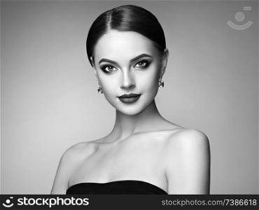 Beautiful Young Woman with Clean Fresh Skin. Perfect Makeup. Beauty Fashion. Eyelashes. Plump Lips. Cosmetic Eyeshadow. Highlighting. Cosmetology, Beauty and Spa. Black and white photo