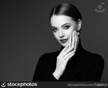 Beautiful Young Woman with Clean Fresh Skin. Perfect Makeup. Beauty Fashion. Plump Lips. Cosmetic Eyeshadow. Smooth Hair. Girl in Black Turtleneck. Black and white photo