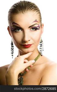 Beautiful young woman with creative make-up on her face