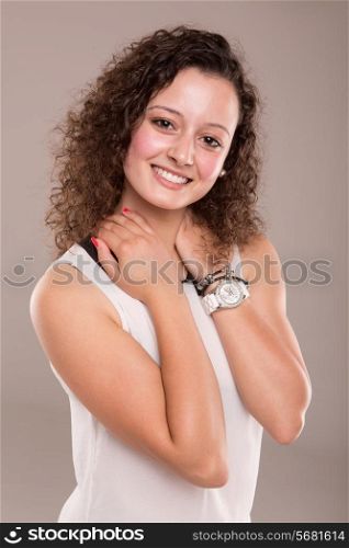 Beautiful young woman with curly hair posing