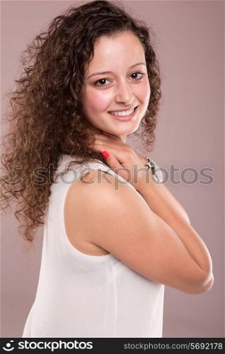 Beautiful young woman with curly hair posing