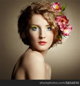 Beautiful young woman with delicate flowers in their hair. Spring photos