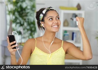 beautiful young woman with earphones listening her favorite music