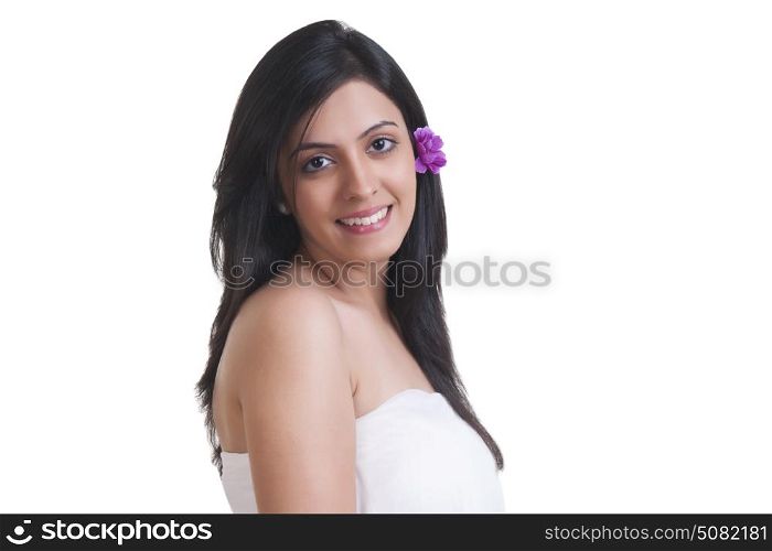 Beautiful young woman with flower in her hair