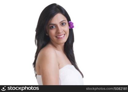 Beautiful young woman with flower in her hair