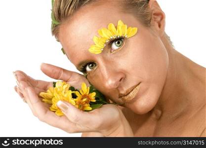 Beautiful young woman with flowers on face and in hand.