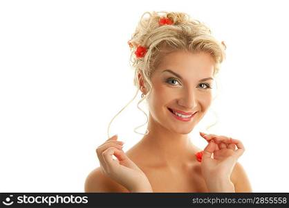 Beautiful young woman with fresh spring flowers in her hair close-up portrait
